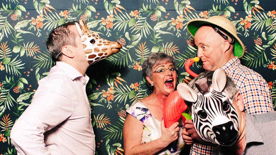 Alemba having fun in the tropical themed photobooth